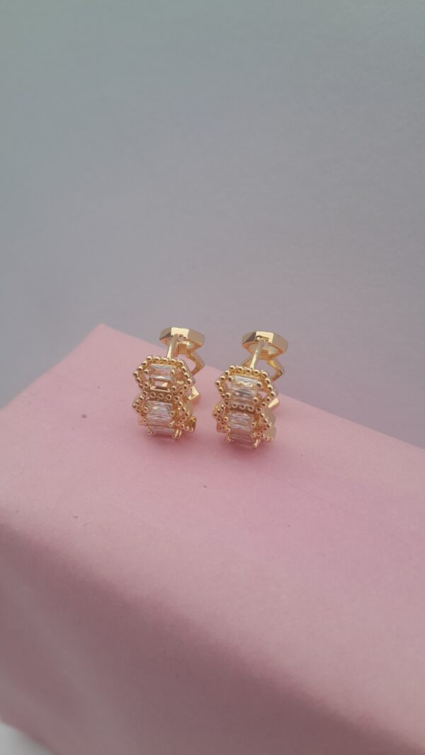 Ladies gold earrings with small silver design