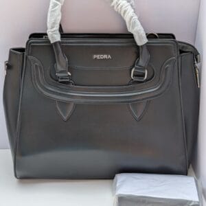 Elegant black work bag for women with sculpted handle detail and silver hardware — shop Pedra black bags with matching purse at Nansey Emporium Ghana