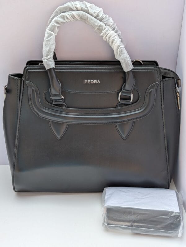 Elegant black work bag for women with sculpted handle detail and silver hardware — shop Pedra black bags with matching purse at Nansey Emporium Ghana